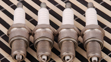 What kinds of spark plugs offer good resistance to carbon build-up?