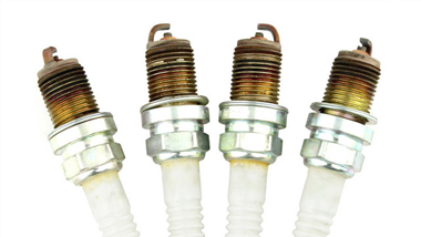 What are the effects of spark plug overheating?